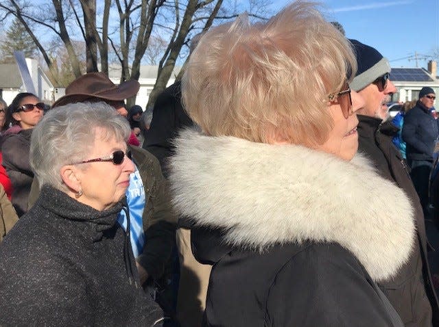 Ocean County Commissioners Bobbi Jo Crea, left, and Ginny Haines listen to speeches before the start of a march in Toms River for the homeless on Saturday.