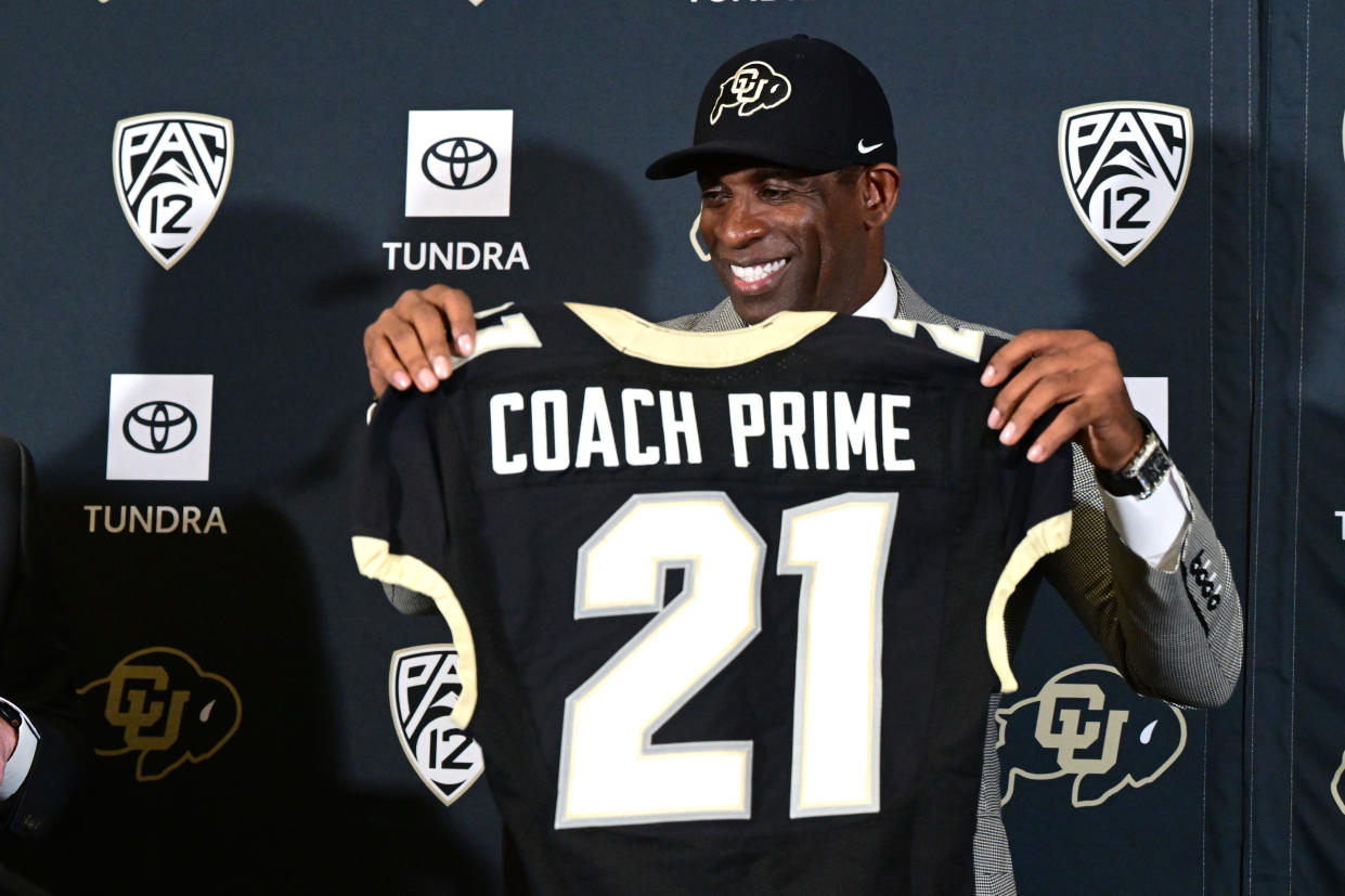 BOULDER, CO - DECEMBER 4:  Deion Sanders, CUs new head football coach, holds up a personalized jersey in the Arrow Touchdown Club during a press conference on December 4, 2022 in Boulder, Colorado. CU held an introductory press conference to announce the hiring of Deion Coach Prime Sanders as the schools new head football coach. Chancellor Phil DiStefano and athletic director Rick George accompanied Sanders into a packed room in the Arrow Touchdown Club inside the Dal Ward Athletic Center. Sanders becomes the 28th head coach in Buffalo football history.  Sanders, who known as Prime Time during his Hall of Fame playing career has since transitioned into Coach Prime as a head football coach. Sanders, 55, joins the CU program from Jackson State University where in three seasons the Tigers compiled a 27-5 record and won back-to-back Southwestern Athletic Conference championships. (Photo by Helen H. Richardson/MediaNews Group/The Denver Post via Getty Images)