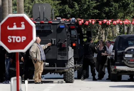 A tourist is helped to a vehicle after an attack by gunmen on Tunisia's national museum in Tunis March 18, 2015. REUTERS/Stringer