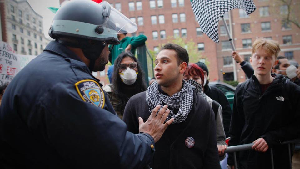 <div>An NYPD officer speaks to a protester as pro-Palestinian demonstrators gather outside of Columbia University in New York City on April 18, 2024. Officers cleared out a pro-Palestinian campus demonstration on April 18, a day after university officials testified about anti-Semitism before Congress. Leaders of Columbia University defended the prestigious New York school's efforts to combat anti-Semitism on campus at a fiery congressional hearing on April 17. (Photo by Kena Betancur / AFP) (Photo by KENA BETANCUR/AFP via Getty Images)</div>