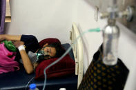 A coronavirus patient receives treatment at a hospital in Najaf, Iraq, Wednesday, July 14, 2021. Infections in Iraq have surged to record highs amid a third wave spurred by the more aggressive delta variant, and long-neglected hospitals suffering the effects of decades of war are overwhelmed with severely ill patients. (AP Photo/Anmar Khalil)
