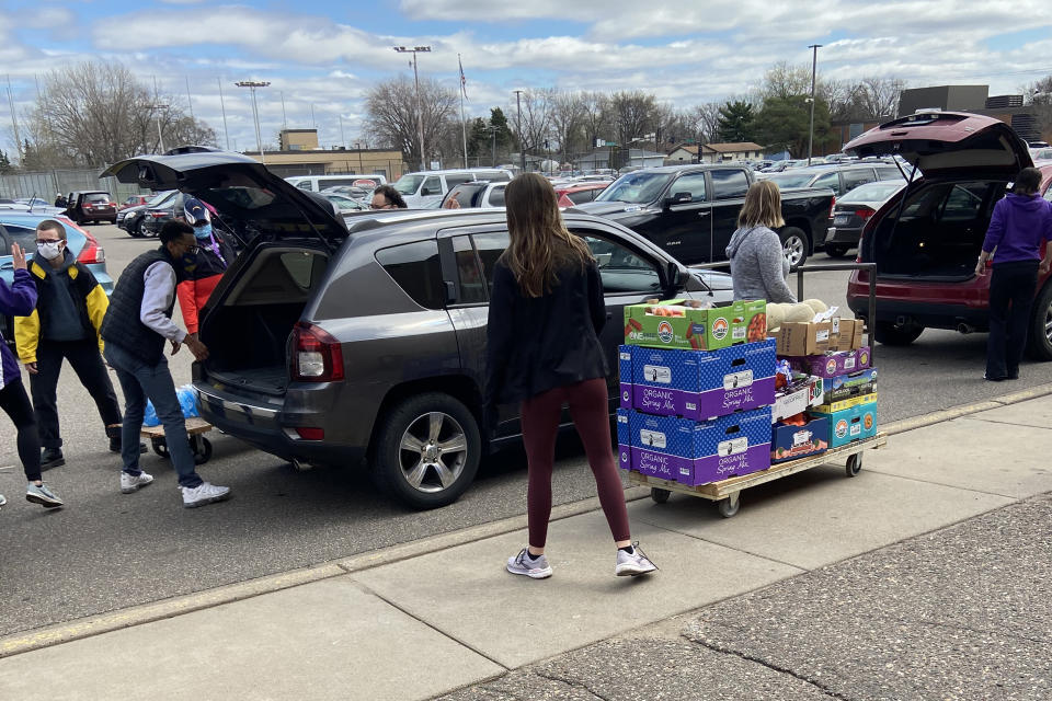 Image: Volunteers load bags of groceries for needy families (Deon J. Hampton / NBC News)