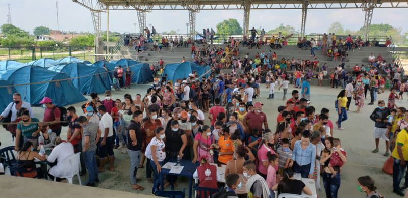 Venezuelan migrants are seen inside a coliseum where a temporary camp is installed, after fleeing their country due to military operations, according to the Colombian migration agency, in Arauquita