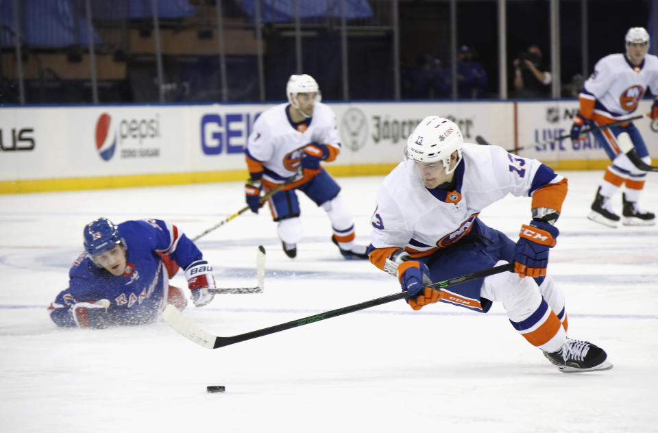 New York Islanders' Mathew Barzal, right, of takes the puck from New York Rangers' Adam Fox, left, during the third period of an NHL hockey game Thursday, Jan. 14, 2021, in New York. (Bruce Bennett/Pool Photo via AP)