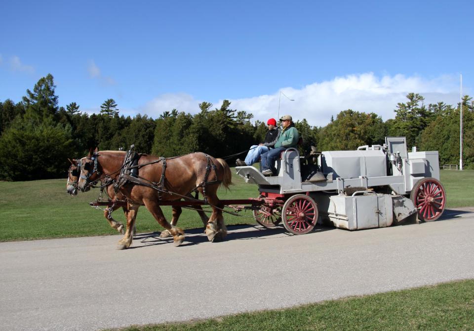 This Sept. 23, 2012 photo shows a horse-drawn vehicle on Mackinac Island, Mich., in Lake Huron. Motor vehicles are not allowed on the island, so bikes and horse carriages are common sights. (AP Photo/Anick Jesdanun)