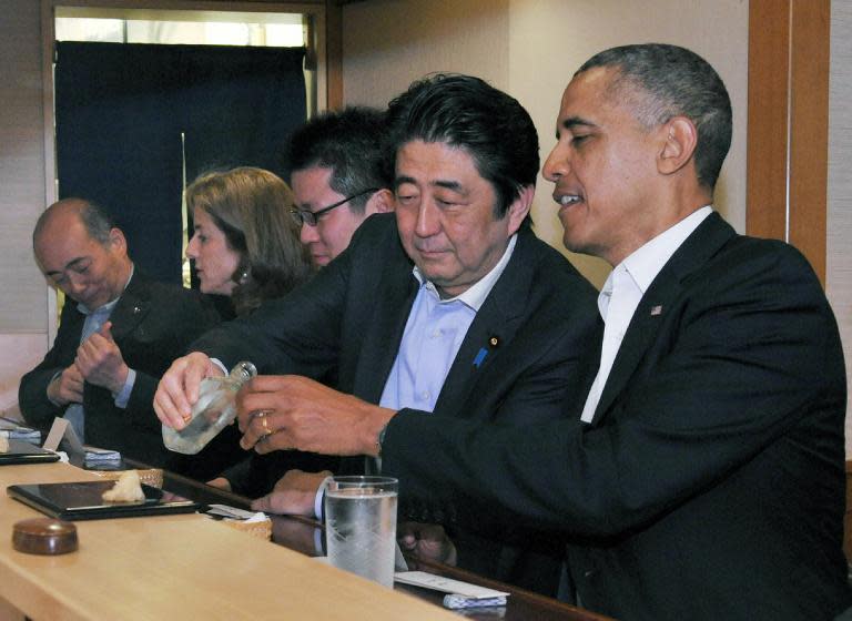 This picture released by Japan's Cabinet Public Relations Office on April 23, 2014 shows Japanese Prime Minister Shinzo Abe (2nd R) talking with US President Barack Obama (R) at Sukiyabashi Jiro restaurant in Tokyo