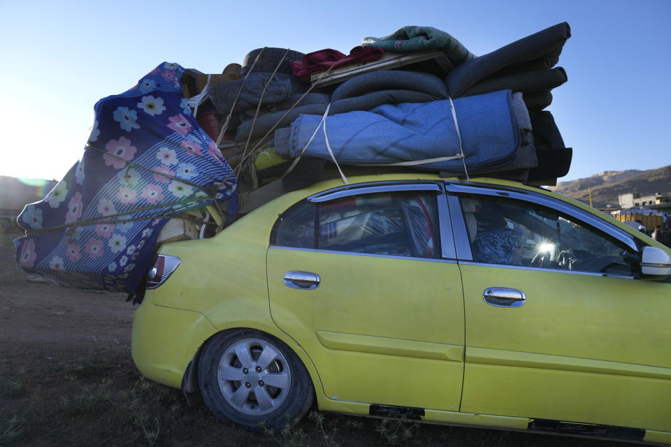 A Syrian refugee woman sits inside a car, as she prepares to go back home to Syria as a part of a voluntary return, in the eastern Lebanese border town of Arsal, Tuesday, May 14, 2024. Hundreds of Syrians refugees left a remote northeastern Lebanese town back to Syria in a convoy, amid a surge in anti-refugee sentiment in the small, crisis-hit country. Lebanese officials for years has urged the international community to resettle the refugees in other countries or help them return to Syria. (AP Photo/Hussein Malla)