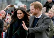 FILE PHOTO: Meghan Markle and Britain's Prince Harry, meet members of the public during a walkabout on the esplanade at Edinburgh Castle