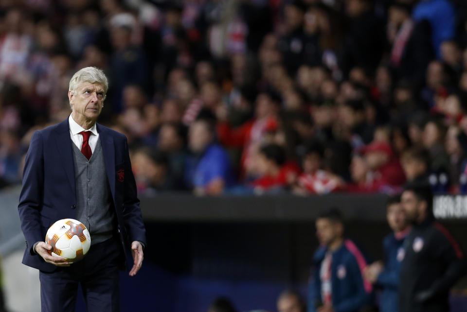 Arsenal manager Arsene Wenger holds the ball during the game