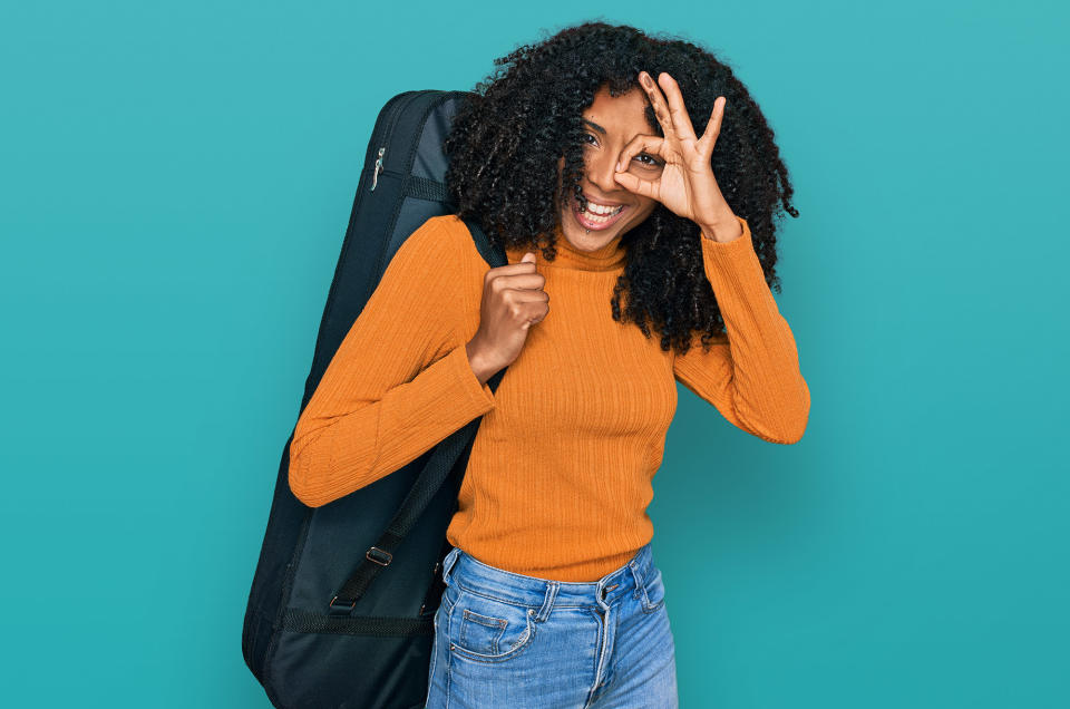 woman with guitar travel case