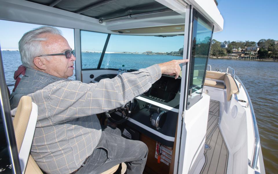 Bobby Switzer talks about Deadman's Island as his boat approaches the island off Gulf Breeze, Fla., on Feb. 24, 2021.