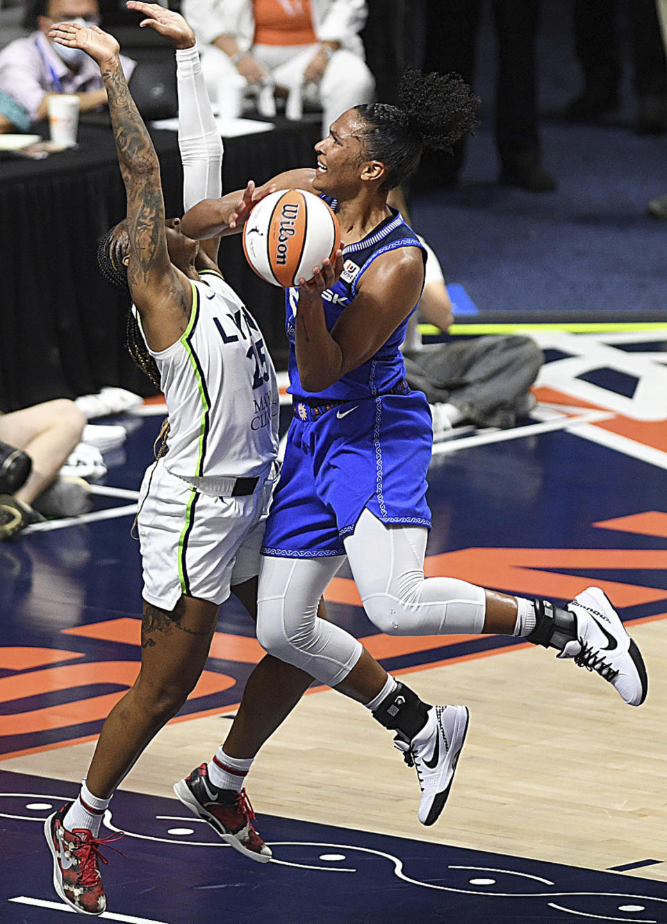 Connecticut Sun's Alyssa Thomas (24) is guarded by Minnesota Lynx's Tiffany Mitchell (25) at the basket during a WNBA basketball game, Sunday, Sept. 17, 2023, at Mohegan Sun Arena in Uncasville, Conn. (Sarah Gordon/The Day via AP)