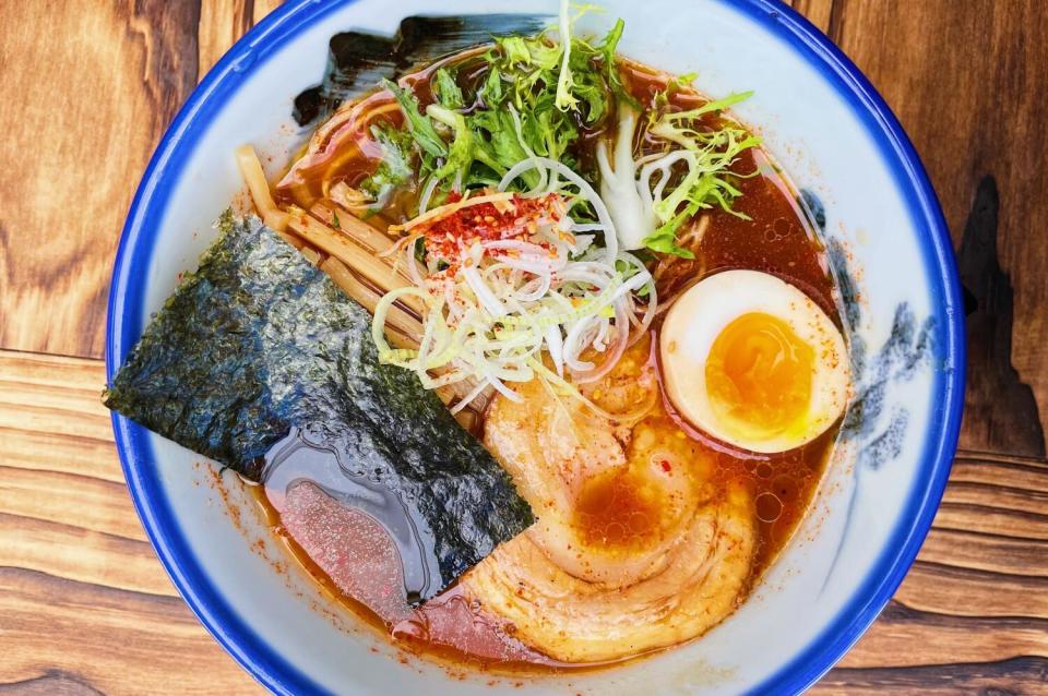 An overhead photo of a blue-rimmed bowl of tonkotsu ramen from Afuri Ramen.