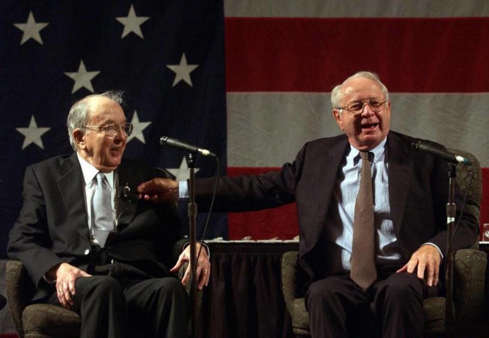 Lauch Faircloth, right, pinches the suit of Jesse Helms, left, while telling a story to those in attendance at the North Carolina Republican Party’s 2003 Hall Of Fame Banquet at the Embassy Suites hotel in Cary.