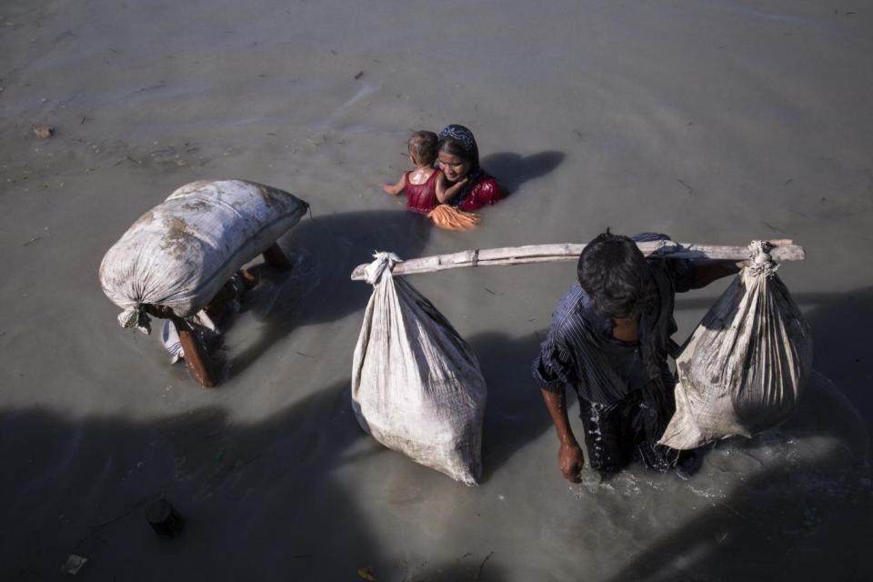 Stranded: Rohingya were waiting for access to dry land in rice paddies near Palangkhali wtih driving tropical rain coming at night (Redux/eyevine)