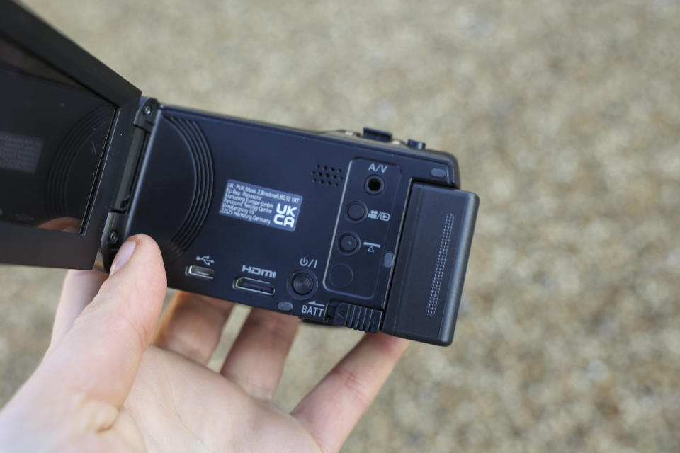 A close-up of the ports on the Panasonic V180 camcorder