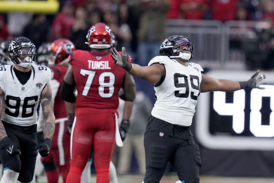 Jacksonville Jaguars defensive end Jeremiah Ledbetter (99) and Adam Gotsis (96) celebrate a missed long field goal attempt by the Houston Texans in the final seconds of an NFL football game in Houston, Sunday, Nov. 26, 2023. (AP Photo/Eric Christian Smith)