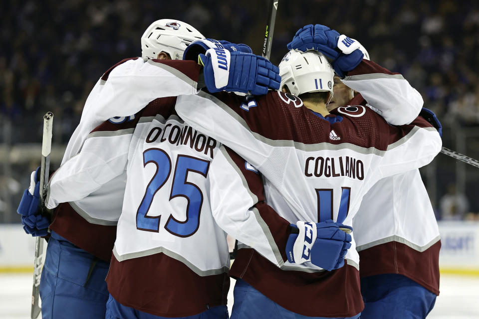 Colorado Avalanche right wing Logan O'Connor (25) celebrates with teammates after scoring a goal against the New York Rangers in the third period of an NHL hockey game Tuesday, Oct. 25, 2022, in New York. The Avalanche won 3-2 in a shootout. (AP Photo/Adam Hunger)