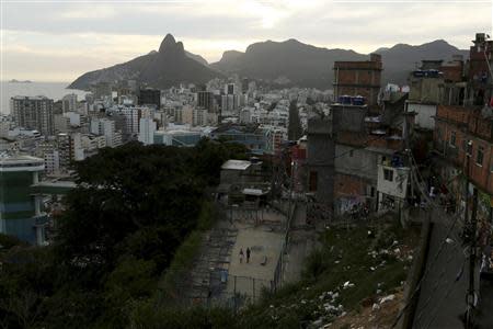 A soccer square in bad conditions and a slope with garbage are seen at the Cantagalo slum in Rio de Janeiro March 13, 2014. REUTERS/Pilar Olivares