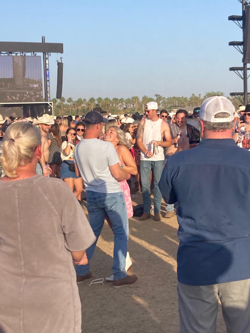 A festivalgoer proposes to his girfriend during Jordan Davis' Mane Stage set at Stagecoach country music festival in Indio, Calif., on Friday, April 29, 2022.