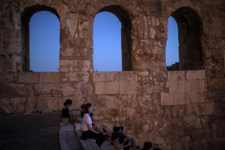 Spectators enjoy a performance at Herodes Atticus in Athens, after the site was reopened on Wednesday, July 15, 2020. Greece opened it's ancient theaters as the country easing coronavirus lockdown measures.(AP Photo/Petros Giannakouris)