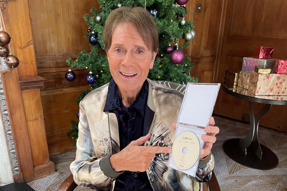 Sir Cliff holding a copy of his festive record (PA Media)