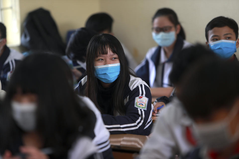 Students wear masks in during a class session at Dinh Cong secondary school in Hanoi, Vietnam on Friday, Jan. 31, 2020. The authorities have advised students to wear masks to school, a day after Vietnam confirmed three more cases of the new virus. (AP Photo/Hau Dinh)