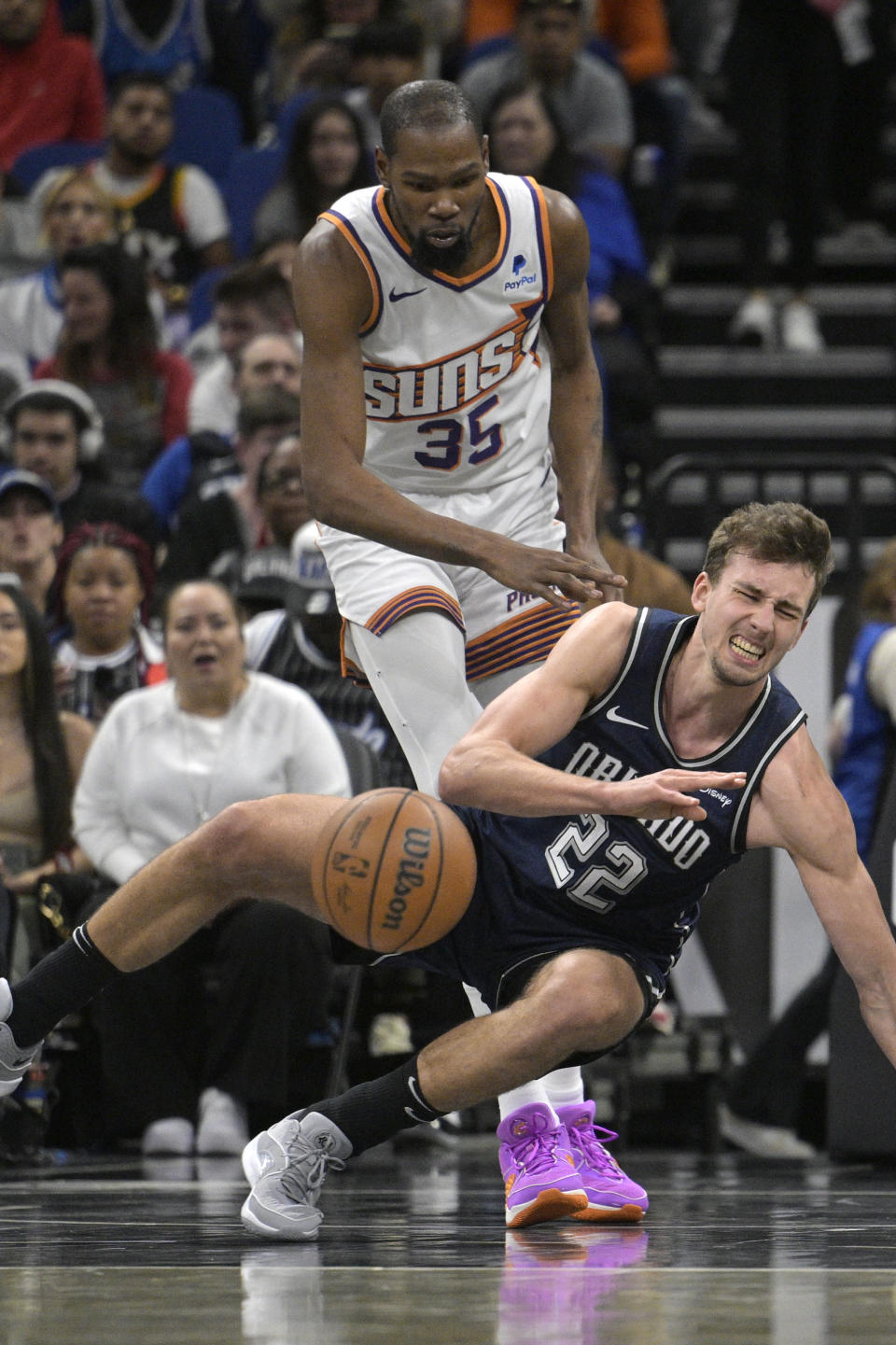 Orlando Magic forward Franz Wagner (22) loses control of the ball while defended by Phoenix Suns forward Kevin Durant (35) during the first half of an NBA basketball game, Sunday, Jan. 28, 2024, in Orlando, Fla. (AP Photo/Phelan M. Ebenhack)