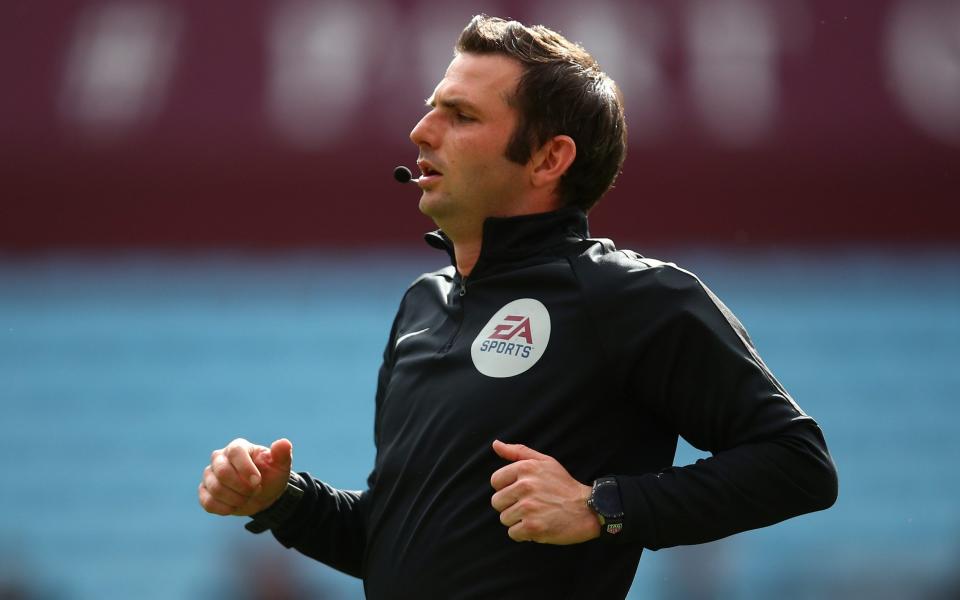 The man in black, with an Elvis quiff: Michael Oliver's hair seemed less tidy than normal - Getty 