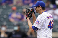 New York Mets starting pitcher Jacob deGrom gets set to throw in the first inning of a baseball game against the Miami Marlins, Saturday, April 10, 2021, in New York. (AP Photo/John Minchillo)