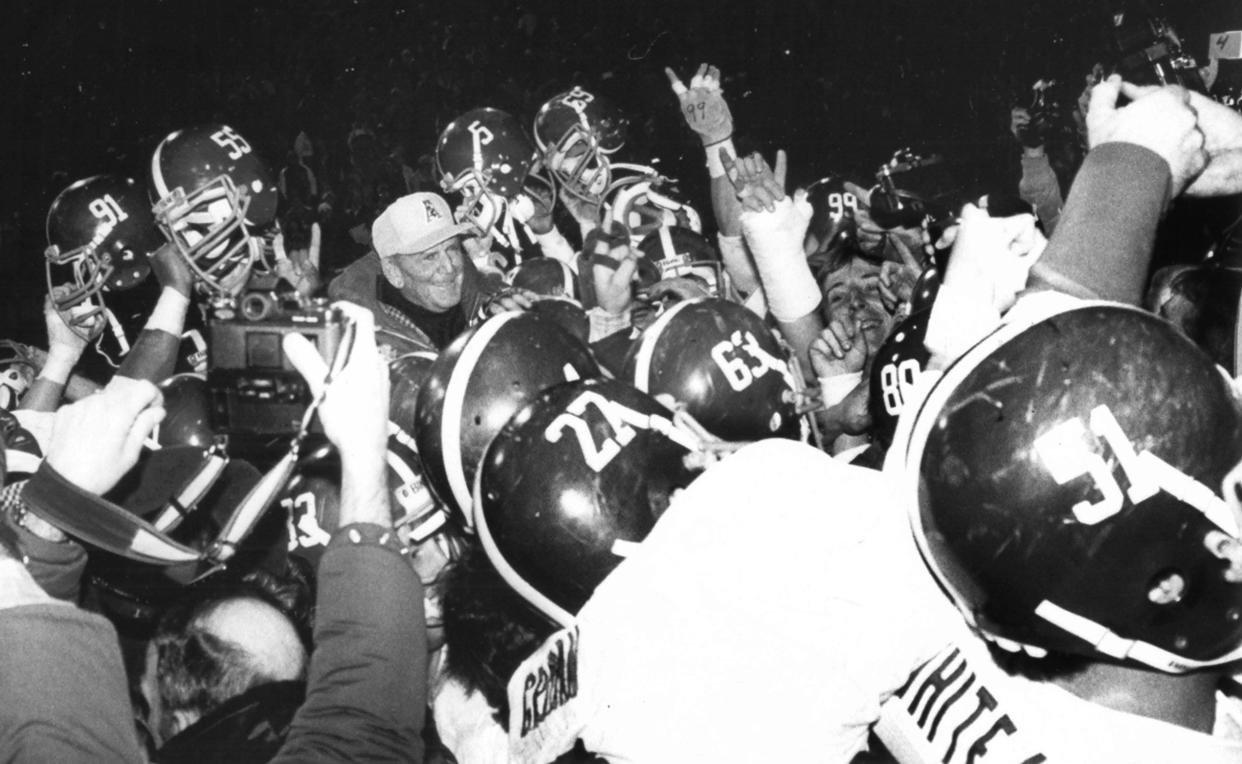 Alabama football coach Paul "Bear" Bryant is surrounded by jubilant players after Alabama beat Illinois 21 to 15 in the Liberty Bowl on 29 Dec 1982 in Bryant's last game as head coach of The Crimson Tide.