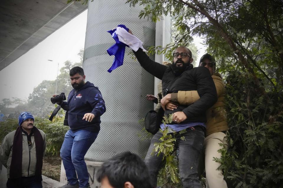 Tensions escalated in the university after a student group said it planned to screen a banned documentary that examines Indian Prime Minister Narendra Modi's role during 2002 anti-Muslim riots, prompting dozens of police equipped with tear gas and riot gear to gather outside campus gates. (Manish Swarup / AP)