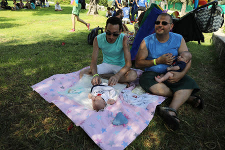 Gay couple, Yuval, 43, and Eli, 36, look after their twin babies during Jerusalem's 17th annual Gay Pride Parade August 2, 2018. REUTERS/Ammar Awad