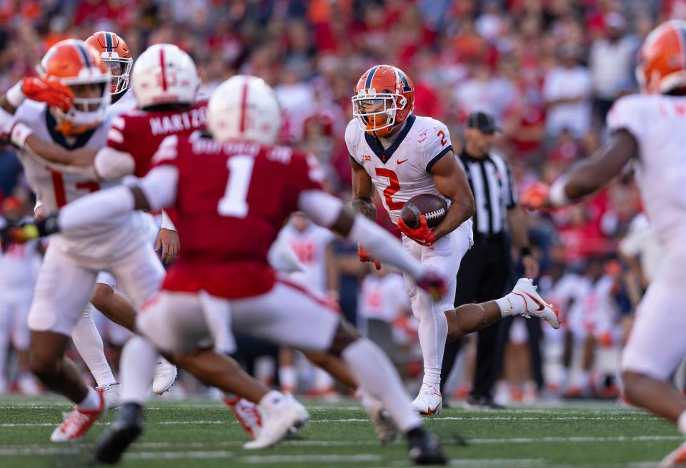 Illinois' Chase Brown (2) carries the ball during the second half of an NCAA college football game against Nebraska, Saturday, Oct. 29, 2022, in Lincoln, Neb. Brown rushed for 149 yards during his team's 26-9 win. (AP Photo/Rebecca S. Gratz)