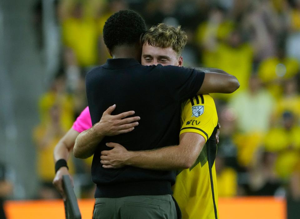 Jun 22, 2024; Columbus, OH, USA; Columbus Crew midfielder Aidan Morris (8) hugs his head coach Wilfried Nancy after getting subbed out against Sporting KC during the second half of their MLS game at Lower.com Field.