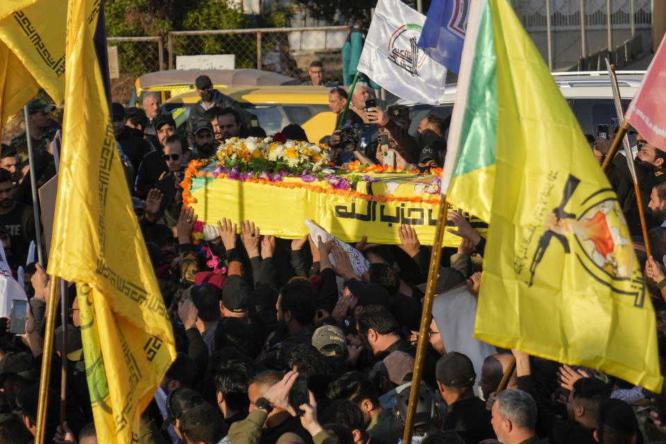 Fighters from the Popular Mobilization Forces, carry the coffin of a commander from the Kataib Hezbollah paramilitary group, Wissam Muhammad Sabir Al-Saadi, known as Abu Baqir Al-Saadi, who was killed in a U.S. airstrike, in Baghdad, Iraq, Thursday, Feb. 8, 2024. The U.S. military says a U.S. drone strike blew up a car in the Iraqi capital Wednesday night, killing the high-ranking commander. (AP Photo/Hadi Mizban)