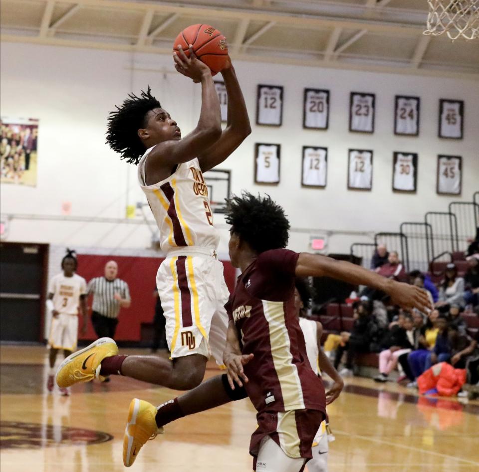 Mount Vernon's Dylan Colon goes up for a shot in front of Arlington's Malaki Smith during the Mount Vernon vs. Arlington boys basketball game at Mount Vernon High School, Dec. 3, 2022.