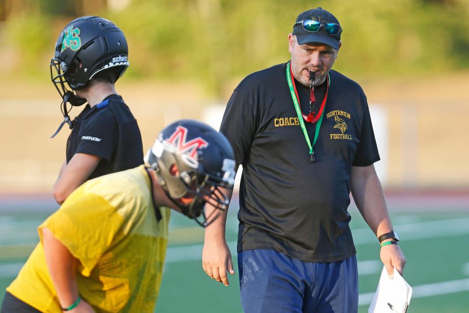 North Smithfield/Mount St. Charles coach Jeff Paiva, right, was happy to be back in action on Monday after a summer clouded by hazing accusations.