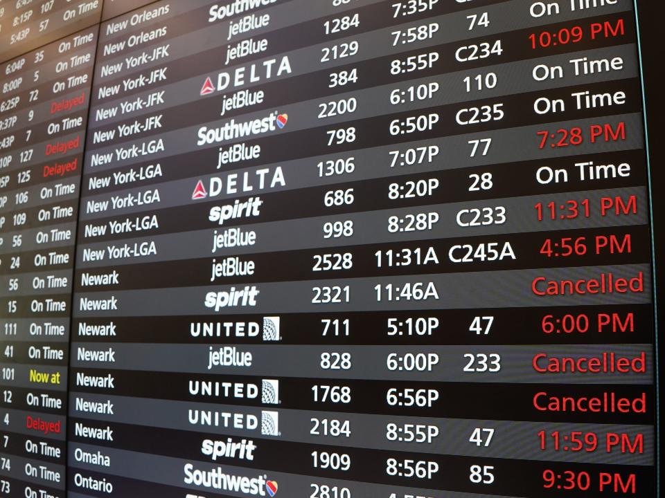 A board showing flight statuses at the airport