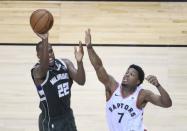 May 21, 2019; Toronto, Ontario, CAN; Milwaukee Bucks forward Khris Middleton (22) shoots a ball as Toronto Raptors guard Kyle Lowry (7) defends during the fourth quarter in game four of the Eastern conference finals of the 2019 NBA Playoffs at Scotiabank Arena. Mandatory Credit: Nick Turchiaro-USA TODAY Sports