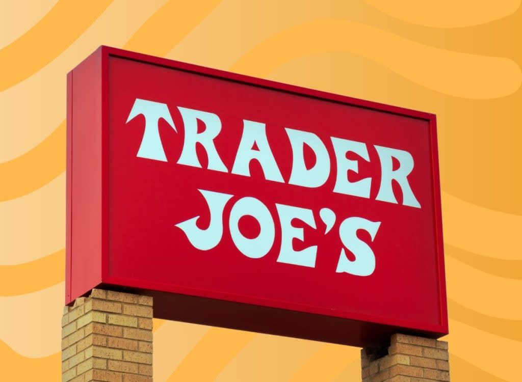 trader joe's sign set against an orange background