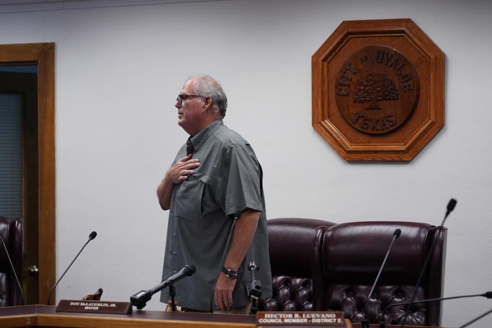 Uvalde Mayor Don McLaughlin, Jr., recites the "Pledge of Allegiance" during a special emergency city council meeting, Tuesday, June 7, 2022, in Uvalde, Texas, to reissue the mayor's declaration of a local state of disaster due to the recent school shooting at Robb Elementary School. Two teachers and 19 students were killed. (AP Photo/Eric Gay)