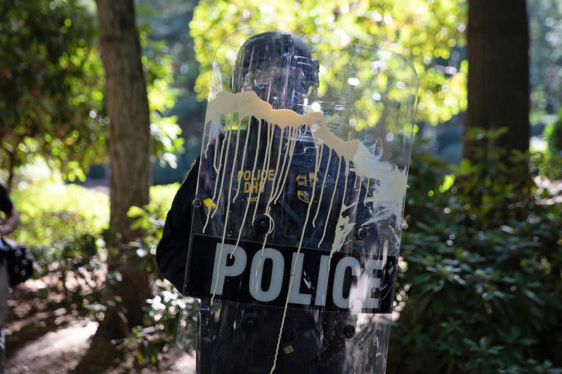 A Portland police officer stands by during a protest in Portland
