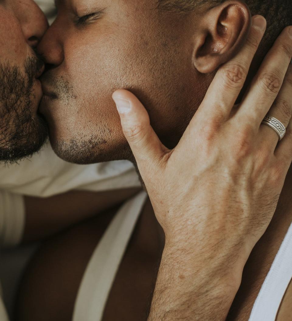 close up of hand touching face with ring visible