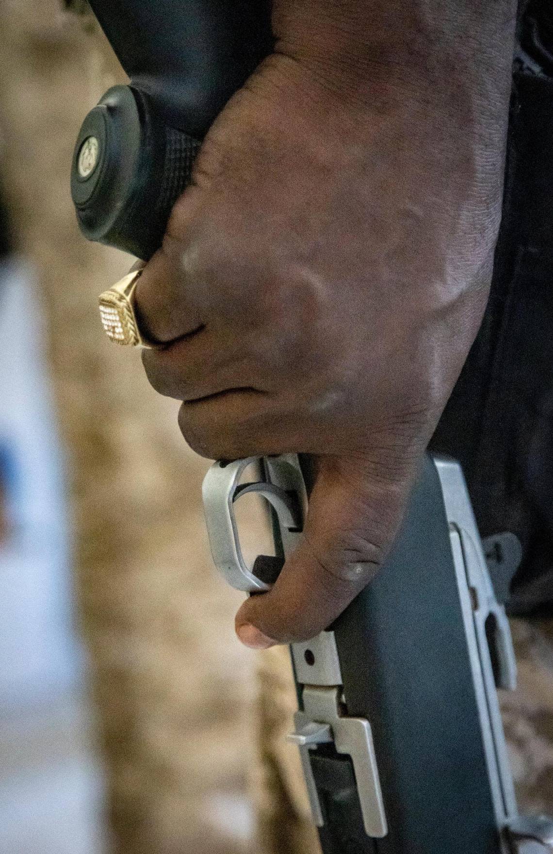 A Haitian policeman holds his gun while on patrol in Port-au-Prince, Haiti, on June 23, 2022. Police say they often lack bullets and body armor to confront gangs.