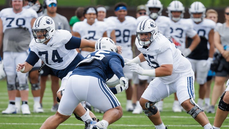 BYU offensive lineman Austin Leausa, left, gets in some work during practice Tuesday, Aug. 13, 2024. The well-traveled Leausa is contending for a starting position on the Cougars' offensive line.