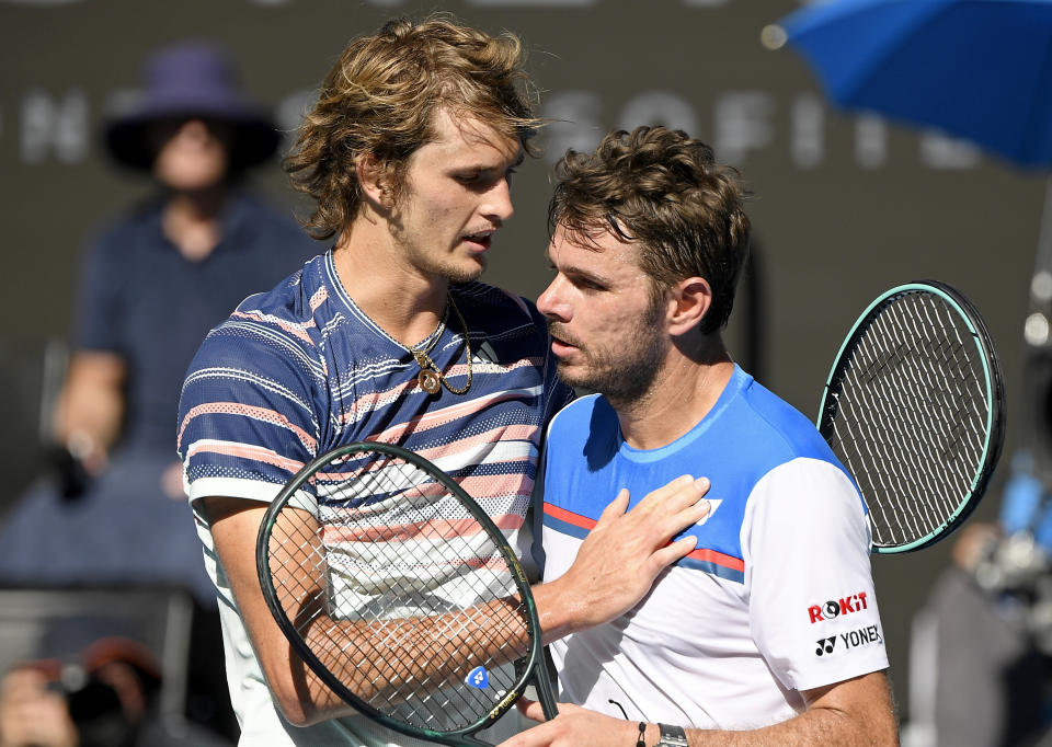 Germany's Alexander Zverev, left, is congratulated by Switzerland's Stan Wawrinka after winning their quarterfinal match at the Australian Open tennis championship in Melbourne, Australia, Wednesday, Jan. 29, 2020. (AP Photo/Andy Brownbill)