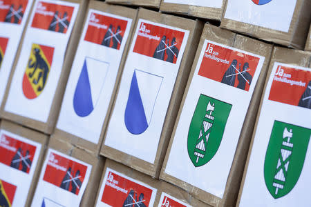 Boxes from the committee for "Yes to a Mask Ban" (Ja zum Verhuellungsverbot), containing more than 100,000 signatures collected that are required to put the proposal of a ban on facial coverings worn by some Muslim women to a national vote, are seen at the Federal Chancellery in Bern, Switzerland September 15, 2017. REUTERS/Moritz Hager