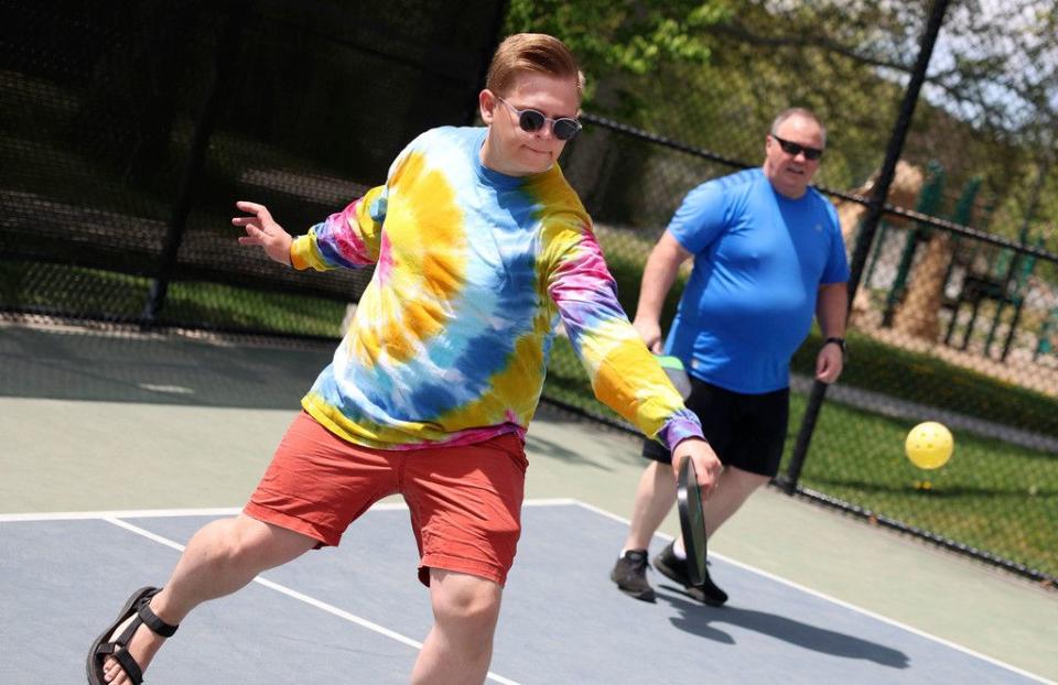 James Ostergar and Mark Mitchell play pickleball with coworkers during a staff picnic at Fairmont Park in Salt Lake City on Friday.