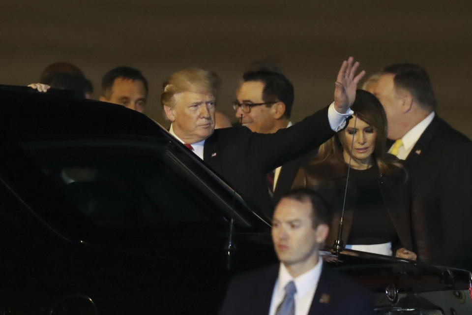 President Donald Trump waves as he and first lady Melania Trump arrive to Ministro Pistarini international airport in Buenos Aires, Argentina, Thursday, Nov. 29, 2018. Trump traveled to Argentina to attend the G20 summit. (AP Photo/Martin Mejia)